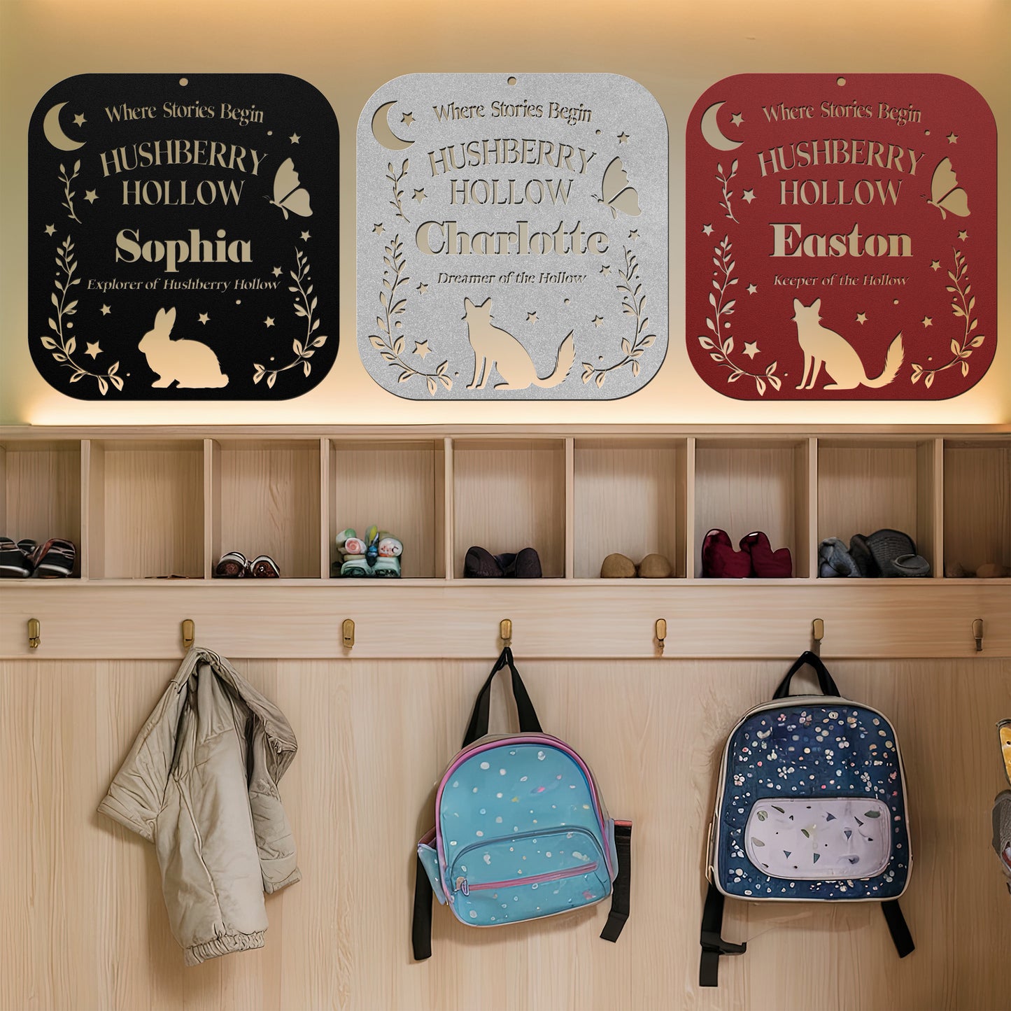 Three personalized signs for children named Hushberry Hollow Sophia, Charlotte, and Easton on a wooden wall with backpacks and shoes below.