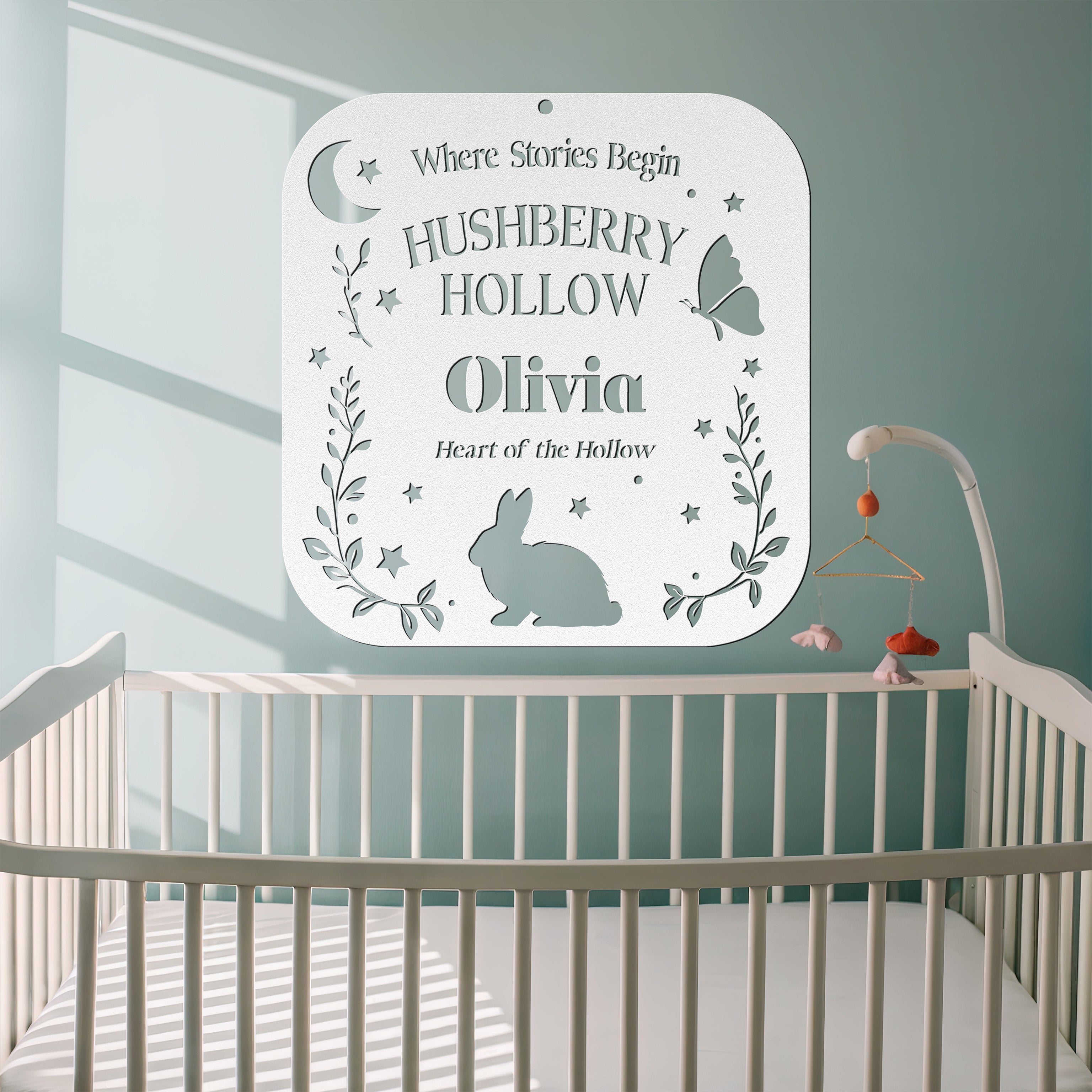 Decorative sign with 'Hushberry Hollow' and 'Olivia' in a nursery setting.