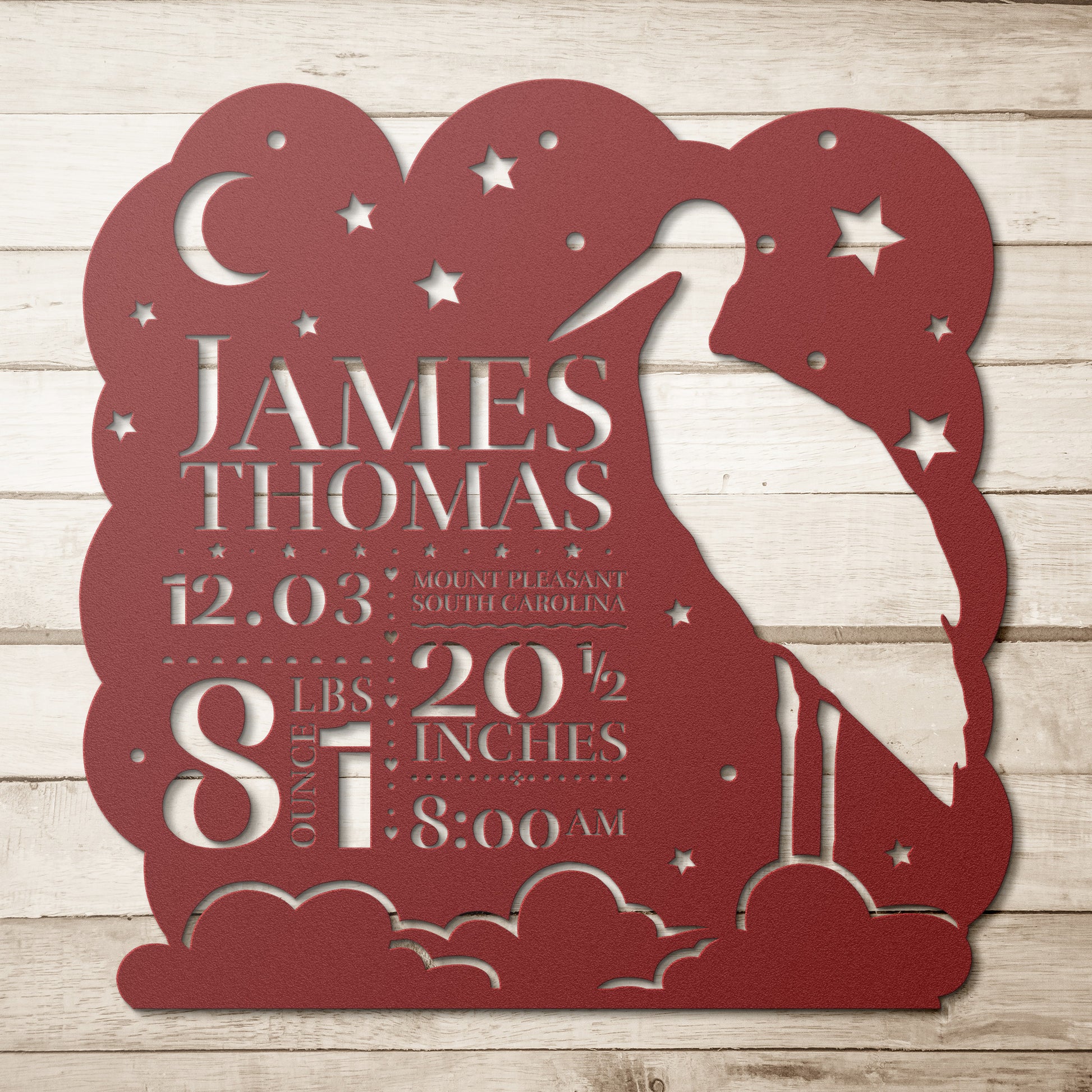 A custom decorative plaque with the name 'James Thomas' and birth details, mounted on a door frame, featuring a starry night design.